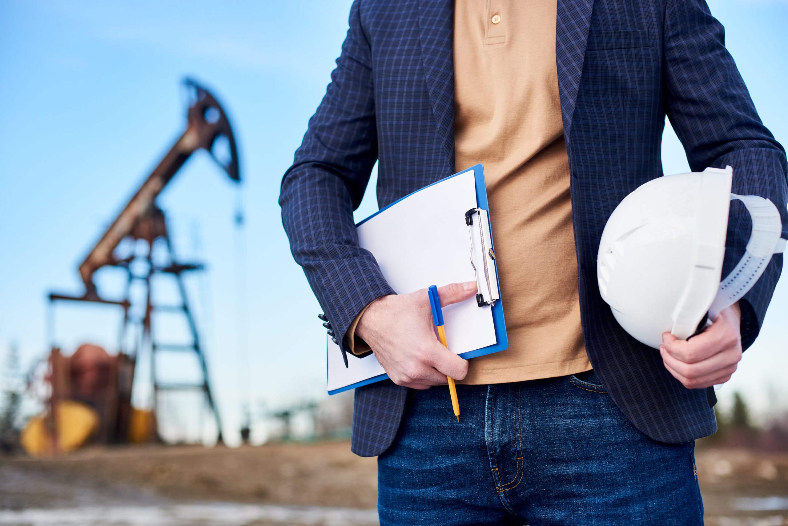 Mining professional reviewing financial documents at a Goldfields mine site, representing commercial debt collection services for Kalgoorlie mining and industrial businesses.
