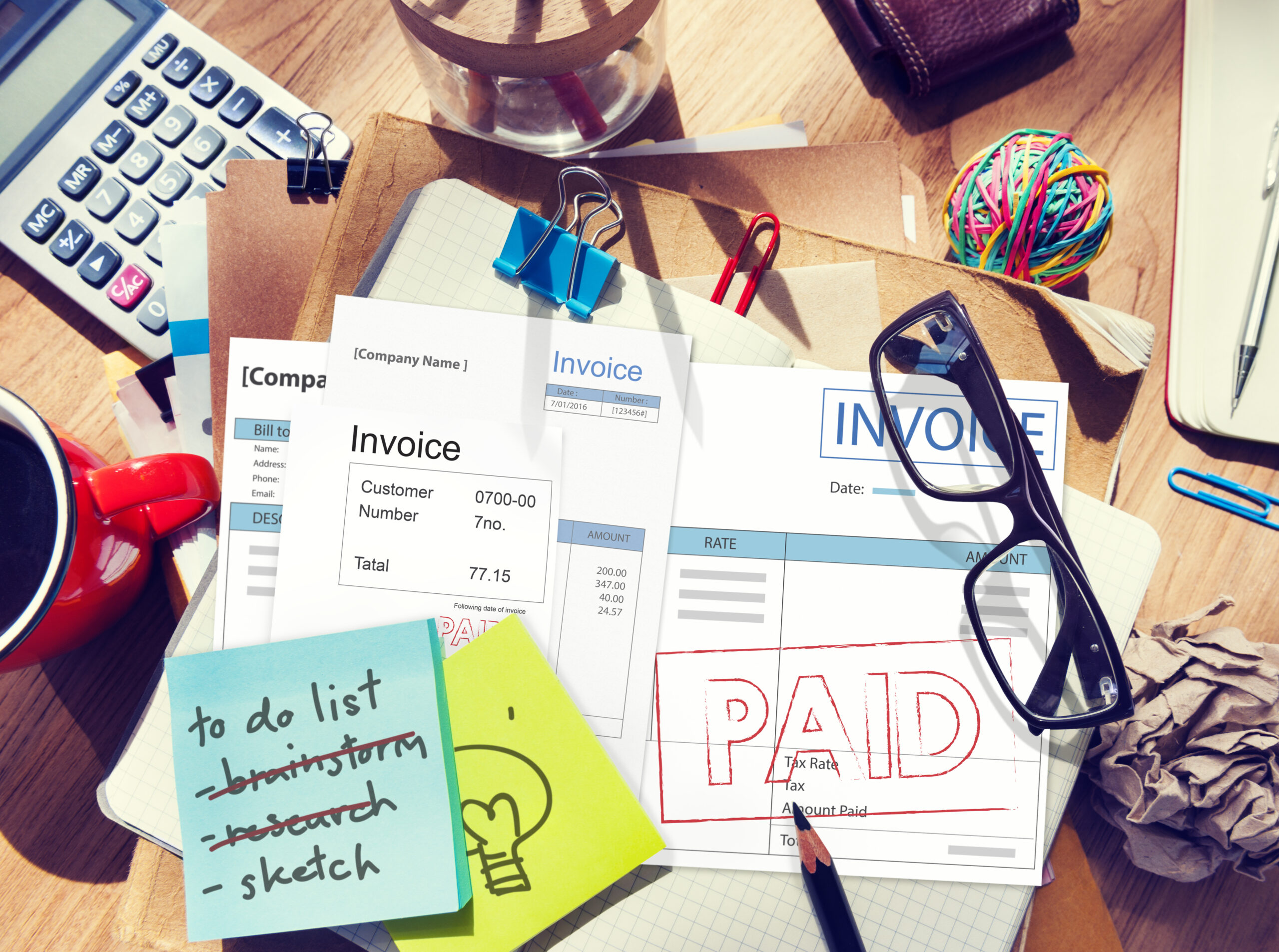 Business owner in Perth reviewing overdue invoices and unpaid accounts, highlighting the challenges WA businesses face with late customer payments and cash flow.