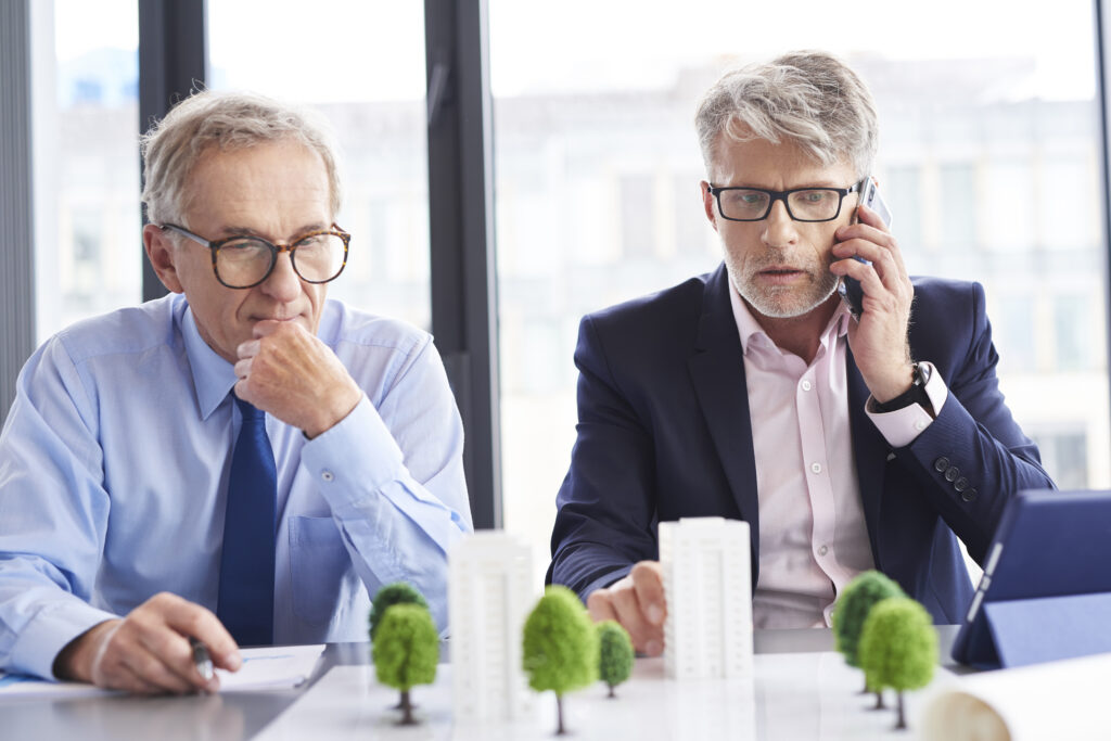 Business professional reviewing overdue invoices and debt recovery documents in a modern Western Australia office.