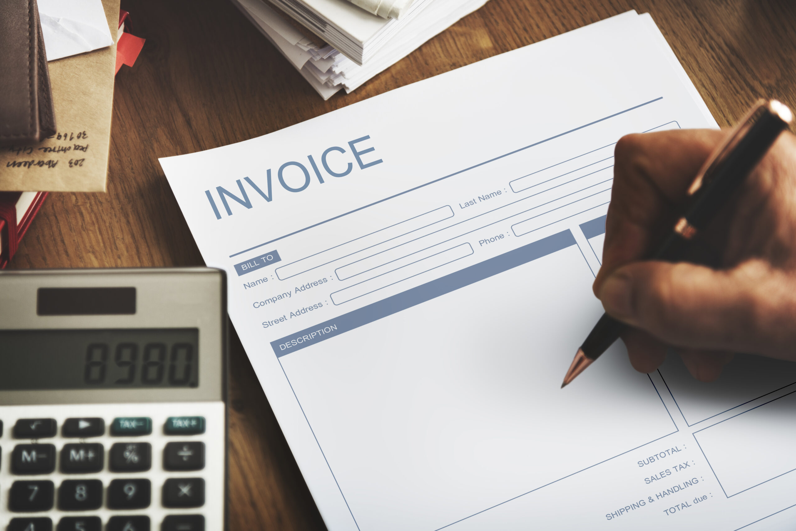 Business professional reviewing unpaid invoices and implementing debt recovery strategies to prevent overdue accounts from becoming bad debts.