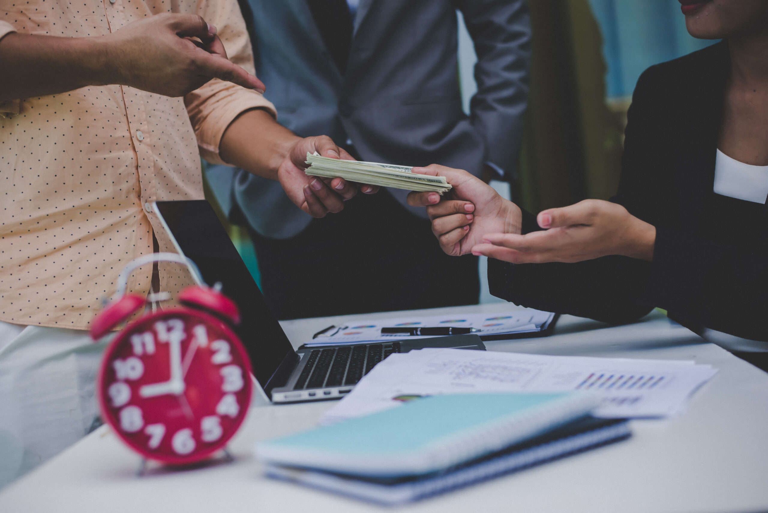 Business owner reviewing overdue invoices and considering a debt collection service