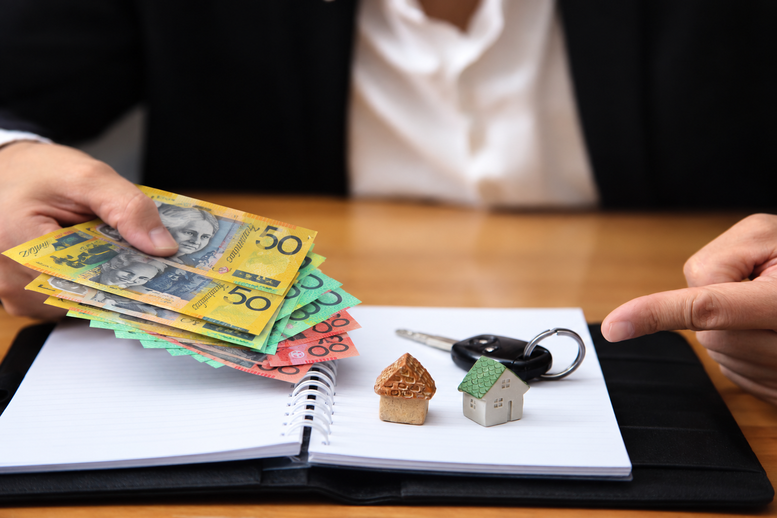 Property manager reviewing unpaid rent records and tenant debt recovery documents for rental properties in Perth, WA
